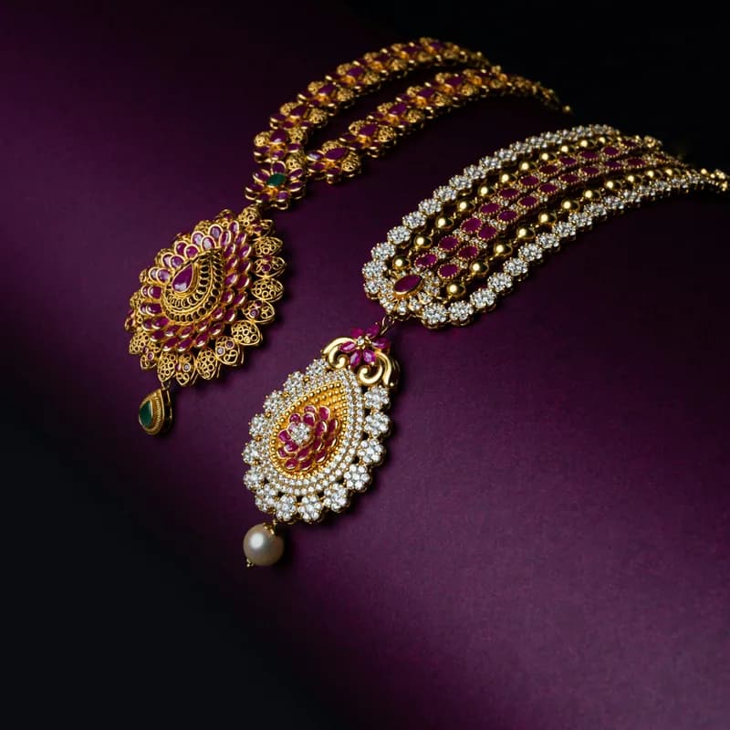Gem-set gold earrings on purple velvet